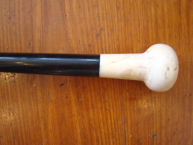 A fine sailor-made ebony walking stick with large carved whale's tooth knob circa 1850